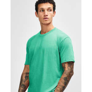A model wearing a unisex short sleeve T-shirt in vibrant mint green, featuring a logo on the sleeve.