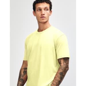 A model wearing a bright yellow unisex short sleeve t-shirt with a simple design and no visible logos.