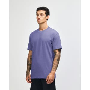 A unisex short sleeve t-shirt in a light purple hue, displayed on a model in a neutral background.