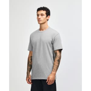 A grey unisex CVC short sleeve t-shirt displayed on a model. The shirt has a simple design and features a logo.