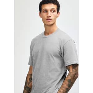 A grey unisex CVC short sleeve T-shirt displayed on a model with a plain background. It features a subtle logo.