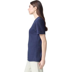 A unisex navy CVC short sleeve T-shirt displayed on a model from the side. The shirt features a logo.