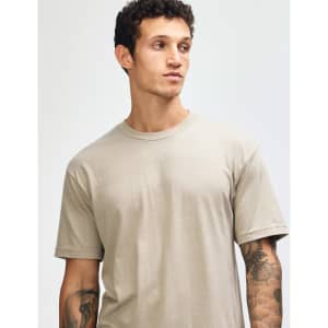 A unisex short sleeve t-shirt in khaki, featuring a relaxed fit and a simple design, with a logo visible.