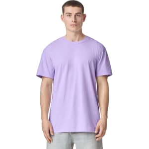A lilac unisex CVC short sleeve T-shirt displayed on a model. The shirt features a simple design and has a logo.