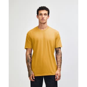 A unisex short sleeve t-shirt in a vibrant mustard colour, displayed on a model. It has a simple design and includes a logo.