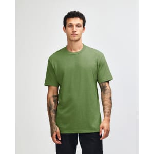 A unisex short sleeve T-shirt in a vibrant green colour, displayed on a model standing against a plain background.