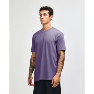 A unisex CVC short sleeve t-shirt in purple, featuring a simple design and a fitted cut.