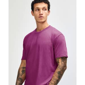 A unisex short sleeve t-shirt in a vibrant magenta colour, worn by a model with a neutral expression.
