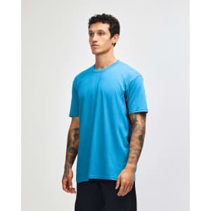 A model wearing a blue unisex short sleeve t-shirt, displaying a simple design and a relaxed fit.