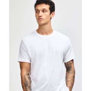 A unisex short sleeve T-shirt in white, featuring a simple design and a logo on the front.