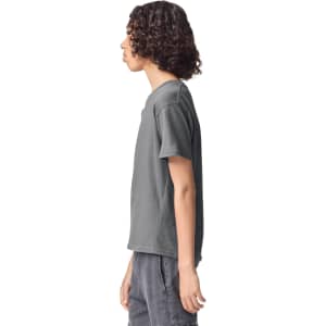 A grey youth t-shirt displayed from the side, featuring a simple design and a small logo.