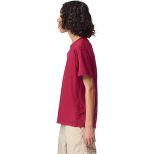 A side view of a youth T-shirt in burgundy, featuring short sleeves and a simple design with a logo.