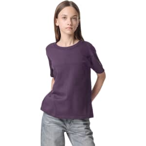 A purple youth t-shirt with short sleeves, featuring a brand logo.