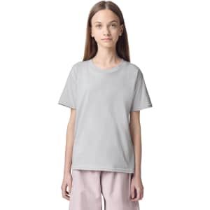 A light grey fine jersey youth t-shirt displayed on a model. The shirt has a simple design and a logo.