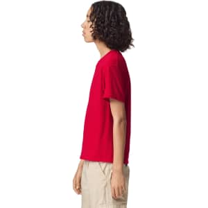 A red youth T-shirt in a side view, featuring short sleeves and a logo on the front.