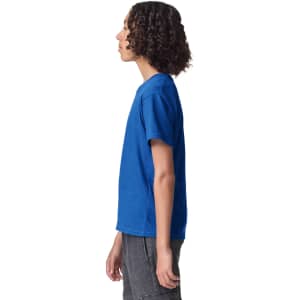 A side view of a blue youth T-shirt, featuring short sleeves and a simple design. The shirt has a logo.