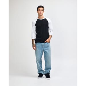 A unisex raglan T-shirt with a black body and white three-quarter sleeves, paired with light blue jeans and black sneakers.