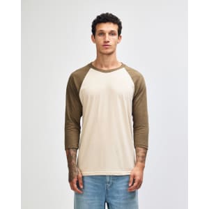 A unisex raglan T-shirt featuring a cream body with olive green sleeves, along with a logo on the front.