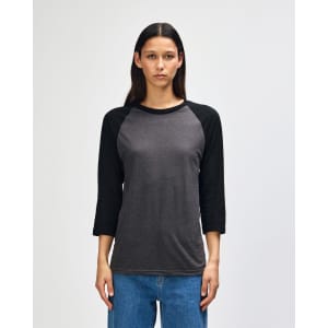 A unisex raglan t-shirt featuring a grey body and black sleeves, with a logo visible on the garment.
