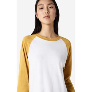 A unisex raglan T-shirt featuring yellow sleeves and a white body. It has a logo on the front.