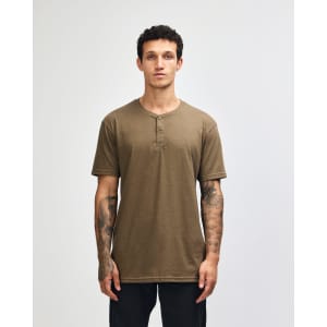 A unisex henley t-shirt in a khaki colour, featuring a round neckline and buttons, displayed on a model.