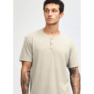 A unisex henley t-shirt in a light beige colour, featuring three buttons at the neckline and short sleeves.