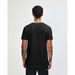 A black unisex V-neck T-shirt from American Apparel, displayed from the back with a person wearing it.