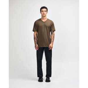 A unisex olive green V-neck T-shirt displayed on a model, featuring short sleeves and a logo.