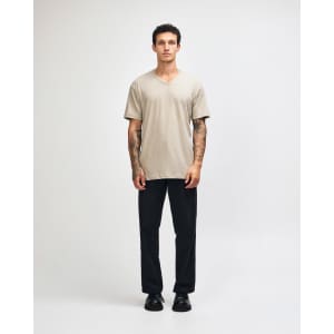 A beige unisex V-neck T-shirt, featuring a relaxed fit and short sleeves, with a branding logo present.