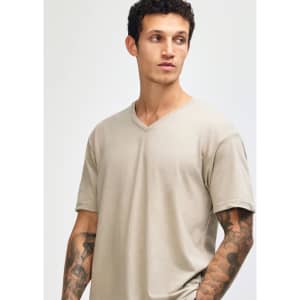 A unisex beige V-neck T-shirt with a relaxed fit, featuring a logo on the side.