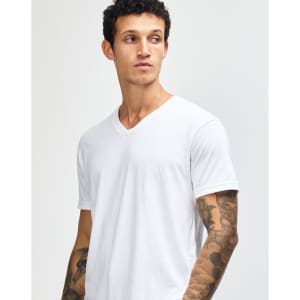 A white unisex V-neck T-shirt featuring short sleeves, displayed on a model. The shirt has a simple design with no visible logos.
