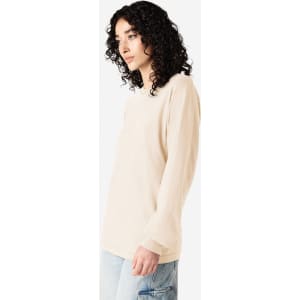 A long sleeve t-shirt in a light beige colour, featuring a logo on the front and a relaxed fit.