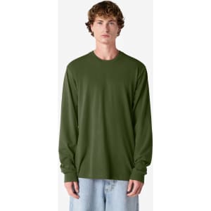 An olive green long sleeve T-shirt on a model, featuring a simple design and relaxed fit. The shirt has a logo.