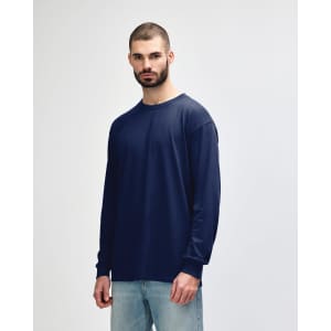 A navy long sleeve t-shirt on a model, featuring a round neckline and a simple design. The shirt has a logo.