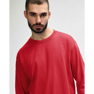 A red long sleeve t-shirt with a relaxed fit, featuring a logo on the front.