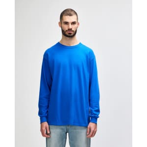 A vibrant blue long sleeve t-shirt with a crew neck, featuring a branded logo on the front.