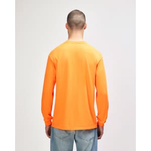 An orange long sleeve T-shirt displayed on a model, featuring a simple design and a logo.