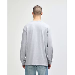 A woman wearing a grey Gildan Ultra Cotton adult long sleeve t-shirt, viewed from the back, paired with navy leggings.