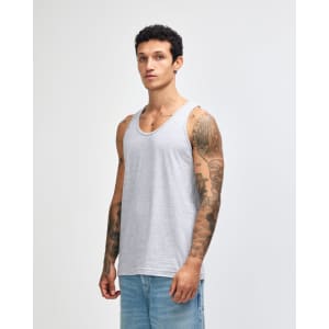 A unisex fine jersey tank in grey, featuring a logo, displayed by a model wearing casual jeans.