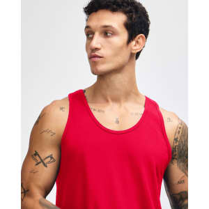 A red unisex fine jersey tank top with a relaxed fit and logo. Model is adjusting the straps.