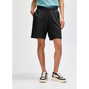Unisex black pique gym shorts with an elastic waistband and side pockets, featuring a logo.