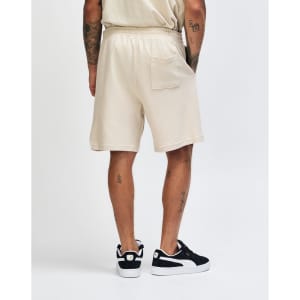 Beige unisex pique gym shorts featuring an elastic waistband and a single back pocket.