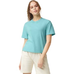 A lightweight, turquoise boxy T-shirt for women, featuring a round neckline and short sleeves. It has a logo.