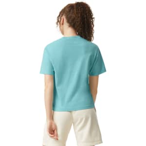 A turquoise women's heavyweight boxy T-shirt, featuring a relaxed fit and short sleeves, with a logo on the back.