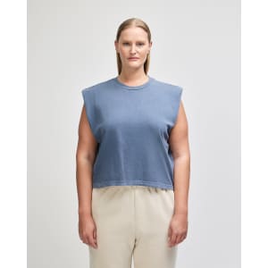 A navy blue women's muscle t-shirt with wide sleeves, displayed on a model, featuring a branded logo.