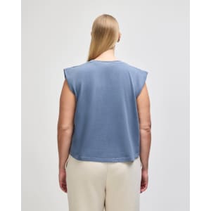 A women's muscle T-shirt in a dark blue shade, featuring short sleeves and a cropped design, with branding on the back.