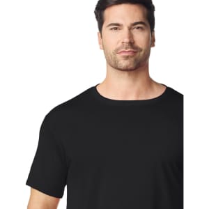 A black Gildan Performance adult t-shirt on a model, showcasing a classic crew neck and short sleeves.