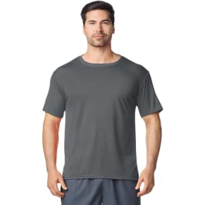 A man wearing a grey Gildan Performance adult t-shirt, featuring a casual fit and short sleeves.