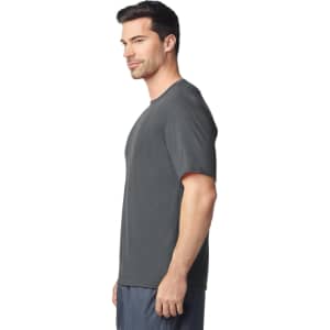 A grey Gildan Performance adult T-shirt displayed on a male model, featuring a logo on the shirt.