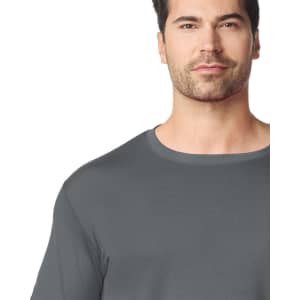 A grey adult t-shirt is displayed on a model, featuring a classic crew neck design and a subtle logo.